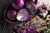 Red cabbage on a cutting board.